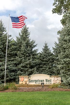 Hudsonville apartment for rent - A sign for Georgetown West is in front of a row of trees.