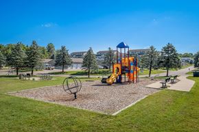 Allegan apartment for rent - A playground with a yellow slide and a blue and yellow tower.