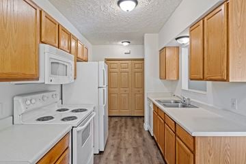 Holland apartment for rent - A kitchen with wooden cabinets and white appliances.