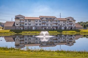 Holland apartment for rent - A building is reflected in a body of water.