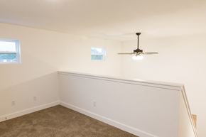Holland apartment for rent - a bedroom with white walls and a ceiling fan