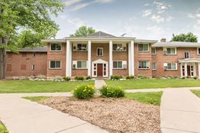Grand Rapids apartment for rent - an apartment building with a red brick facade and a sidewalk