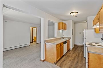 Wyoming apartment for rent - A kitchen with wooden cabinets and a white fridge.