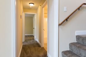Wyoming apartment for rent - a hallway with carpeted stairs and a hall way with a door to a bedroom