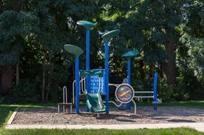 Wyoming apartment for rent - a playground with a blue swing set in a park