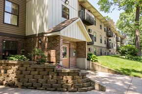Wyoming apartment for rent - the front of a house with a stone retaining wall and a sidewalk