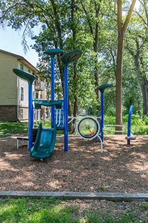 Wyoming apartment for rent - a playground with swings and a clock in a park