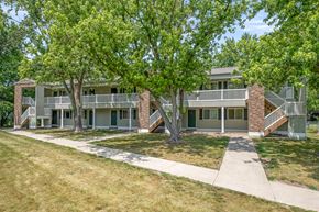 Wyoming apartment for rent - A tree in front of a building.