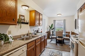 Grand Rapids apartment for rent - A kitchen with wooden cabinets and a granite countertop.