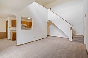 Grand Rapids apartment for rent - A spacious room with a staircase leading to the upper floor.