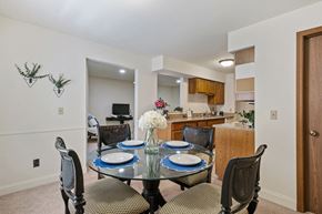 Comstock Park apartment for rent - A dining room with a glass table and chairs.