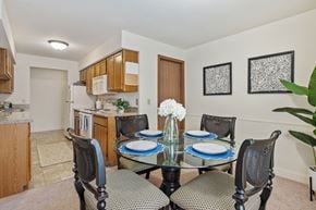 Comstock Park apartment for rent - A dining room with a glass table and chairs.
