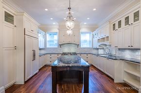 Chicago apartment for rent - a large kitchen with white cabinets and a black counter top