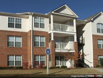 Atlanta apartment for rent - A blue sign with a white arrow pointing to the right is in front of a building.