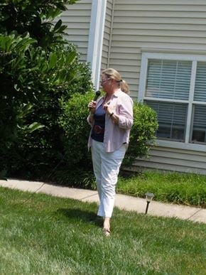 Pineville apartment for rent - A woman in a striped shirt and white pants is standing on a sidewalk.