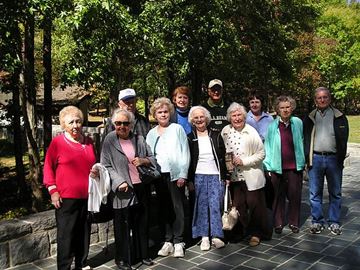 Pineville apartment for rent - A group of people are standing in front of trees.