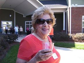 Pineville apartment for rent - A woman in a red shirt is holding a glass with a sticker on it.