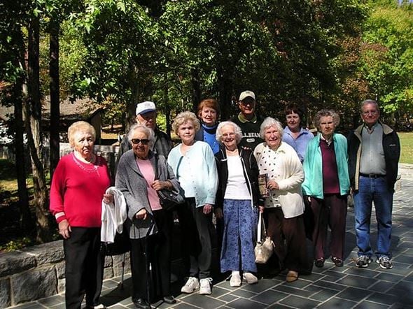 Pineville apartment for rent - A group of people are standing in front of trees.