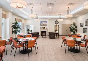 Bloomfield apartment for rent - a dining room with tables and chairs and a fireplace