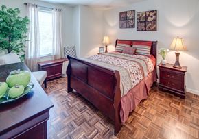 Bloomfield apartment for rent - a bedroom with a bed and a dresser and a window