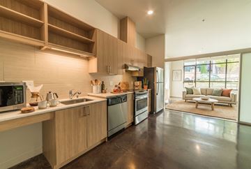 Seattle apartment for rent - A modern kitchen with wooden cabinets and stainless steel appliances.
