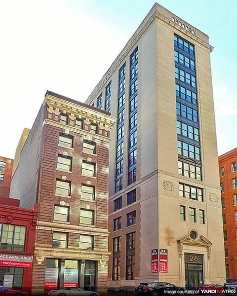 Baltimore apartment for rent - two tall buildings are next to each other on a city street