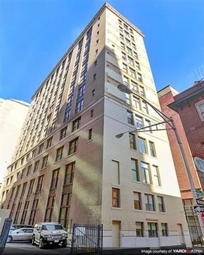 Baltimore apartment for rent - a tall building with a car parked in front of it
