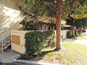Anaheim apartment for rent - a house with a fence and a tree