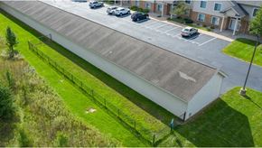 Grandville apartment for rent - an aerial view of a building with cars parked in a parking lot