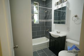 Chicago apartment for rent - A bathroom with a white sink and a black cabinet.
