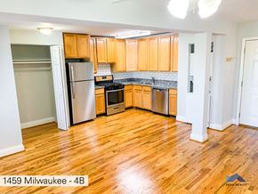 Chicago apartment for rent - a kitchen with wooden floors and stainless steel appliances