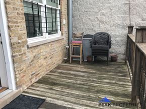 Chicago apartment for rent - a porch with a chair and a table on it