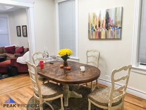 Chicago apartment for rent - a dining room with a table and chairs and a painting on the wall