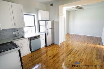 Chicago apartment for rent - A kitchen with wooden floors and white appliances.
