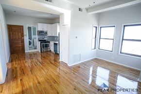 Chicago apartment for rent - A kitchen with wooden floors and white walls.