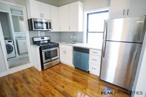 Chicago apartment for rent - A kitchen with wooden floors and stainless steel appliances.