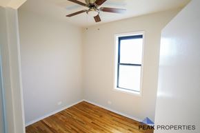 Chicago apartment for rent - A room with a ceiling fan and a window.