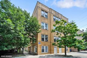 Chicago apartment for rent - a brick building with trees in front of it