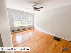 Chicago apartment for rent - the living room of a home with wood floors and a ceiling fan