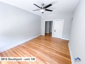 Chicago apartment for rent - the interior of a room with wood flooring and a ceiling fan