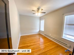 Chicago apartment for rent - the bedroom of a home with wood flooring and a ceiling fan