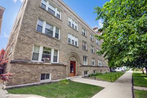 Chicago apartment for rent - a large brick building with a sidewalk in front of it