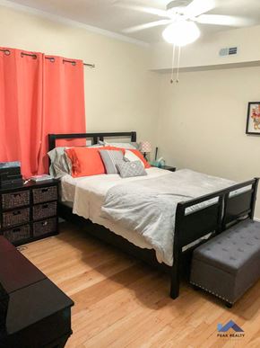 Chicago apartment for rent - a bedroom with a bed and a dresser and a ceiling fan