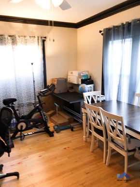 Chicago apartment for rent - a dining room with a table and chairs and a bike in the corner