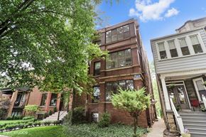 Chicago apartment for rent - a red brick apartment building with trees and a sidewalk