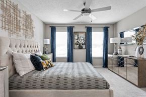 Memphis apartment for rent - Spacious bedroom with plush carpeting, tall windows, and ceiling fan