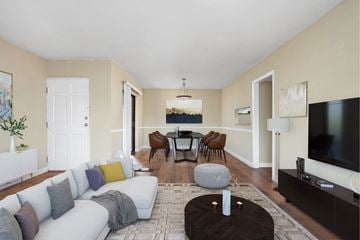 Chattanooga apartment for rent - A living room with a white couch and a grey ottoman.
