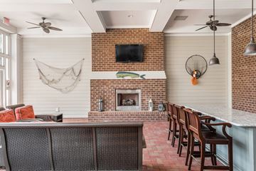 Daniel Island apartment for rent - A living room with a fireplace and a television above it.