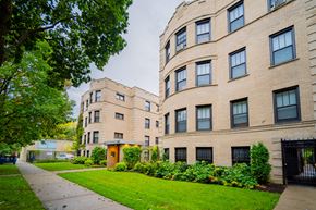 Chicago apartment for rent - a sidewalk in front of a brick apartment building