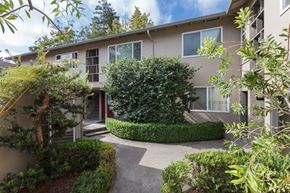 Sunnyvale apartment for rent - an apartment building with a courtyard and trees in front of it